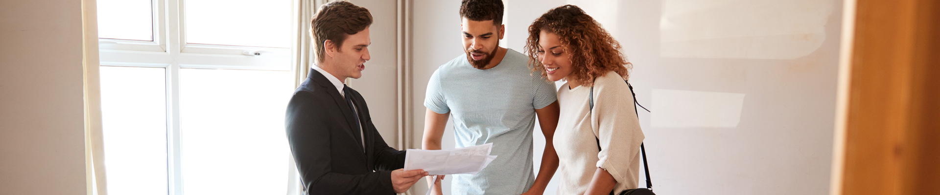 Couple talking to estate agent